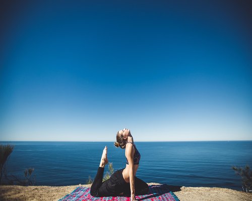 Woman doing gentle stretching yoga outdoors
